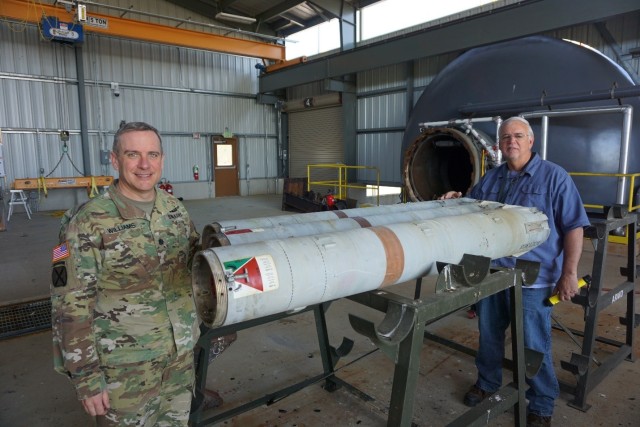 LEMC Commander LTC Dennis Williams and LEMC employee Chuck Grove with the 500th successful rocket motor processed through LEMC’s ARMD facility.
