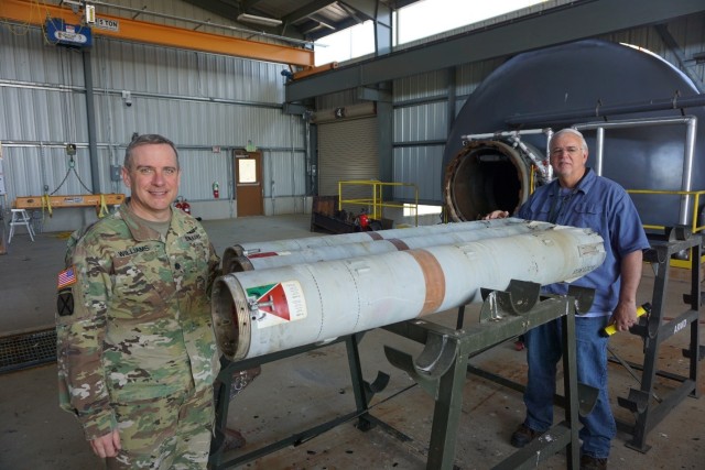 LEMC Commander LTC Dennis Williams and LEMC employee Chuck Grove with the 500th successful rocket motor processed through LEMC’s ARMD facility. 