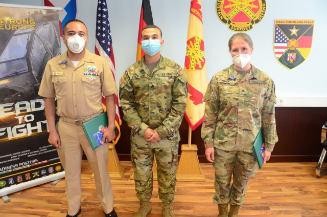 U.S. Army Garrison Rheinland-Pfalz Better Opportunities for Single Service Members (BOSS) President Army Spc. Ethan Locklear recognizes Chief Hospital Corpsman Armando Montoya (left), Naval Medical Logistics Command Detachment, U.S. Army Medical...