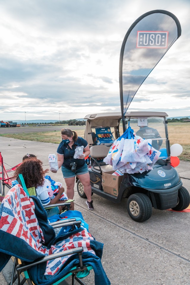 WIESBADEN, Germany - Grace Lauer, center operations manager for the USO, distributes food and goodie bags July 4, 2020.