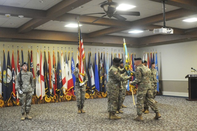 Col. Ryan Roseberry, Fort Polk garrison commander, passes the colors to Lt. Col. Lisbon Williams, incoming Mission and Installation Contracting Command commander at a change of command ceremony held at the Fort Polk Warrior Center June 25.