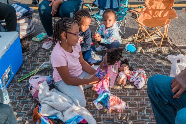 WIESBADEN, Germany - While waiting for the fireworks display to commence, children entertain themselves with dolls and toys on a blanket in front of the family vehicle July 4, 2020 at Wiesbaden Army Airfield.