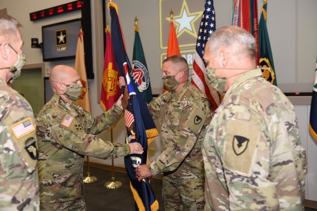 Gen. Ed Daly takes command of the Army Materiel Command as he returns the AMC flag to Command Sgt. Maj. Rodger Masker during a Passing of the Colors ceremony July 2. The Passing of the Colors was part of the change of command ceremony, and included previous AMC Commander Gen. Gus Perna and Army Chief of Staff Gen. James McConville. (U.S. Army Photo by Doug Brewster)
