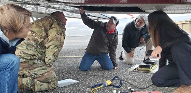 The JALBTCX team showing COL. Thomas Asbery, Former District Commander, New York District, U.S. Army Corps of Engineers the airborne remote sensing platforms on their aircraft.