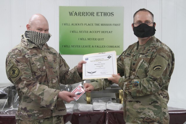 U.S. Army Maj. Erik Peterson, from the Colorado National Guard's 117th Space Support Battalion, 1st Space Brigade, U.S. Army Space and Missile Defense Command, receives the Basic Space Badge, in CENTCOM's area of responsibility, June 26, 2020....