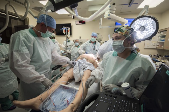 Members of the 555th Forward Surgical Team assess a simulated trauma patient during training with the Strategic Trauma Readiness Center of San Antonio (STaRC) at Brooke Army Medical Center, Fort Sam Houston, Texas, May 28, 2020. The STaRC training...