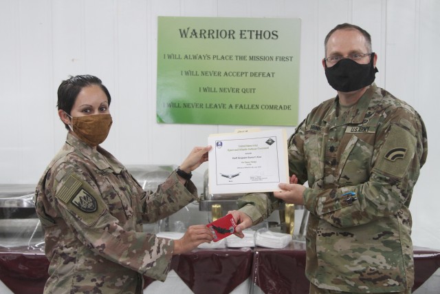 U.S. Army Staff Sgt. Sonia Kiva, from the Colorado National Guard's 117th Space Support Battalion, 1st Space Brigade, U.S. Army Space and Missile Defense Command, receives the Basic Space Badge, in CENTCOM's area of responsibility, June 26,...