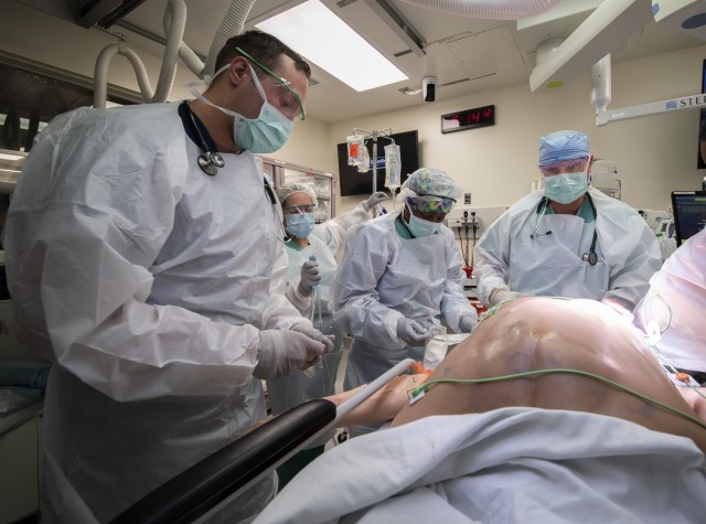 Members of the 555th Forward Surgical Team assess a simulated trauma patient during training with the Strategic Trauma Readiness Center of San Antonio (STaRC) at Brooke Army Medical Center, Fort Sam Houston, Texas, May 28, 2020. The STaRC training...