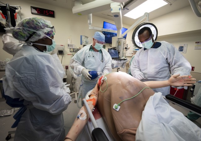 Members of the 555th Forward Surgical Team assess a simulated trauma patient during training with the Strategic Trauma Readiness Center of San Antonio (STaRC) at Brooke Army Medical Center, Fort Sam Houston, Texas, May 28, 2020. The STaRC training...