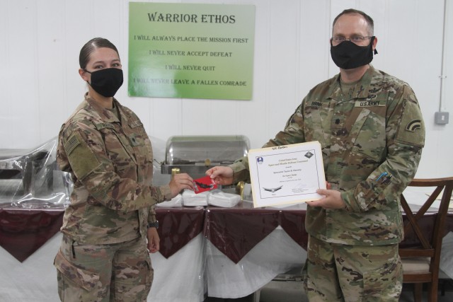 U.S. Army Spc. Taylor Ramsey, from the Colorado National Guard's 117th Space Support Battalion, 1st Space Brigade, U.S. Army Space and Missile Defense Command, receives the Basic Space Badge, in CENTCOM's area of responsibility, June 26, 2020....
