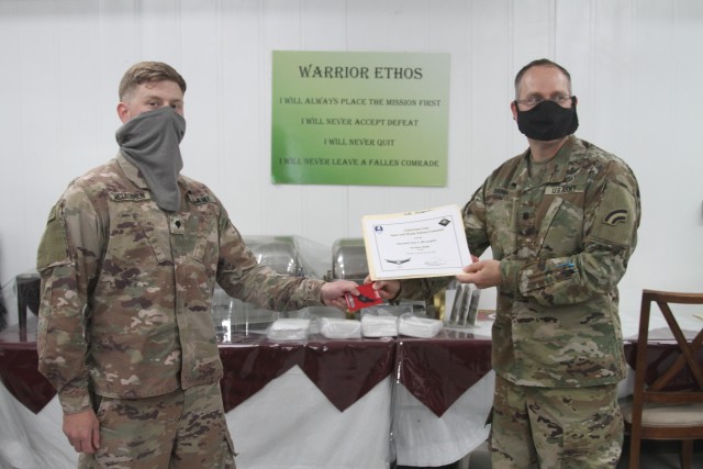 U.S. Army Spc. Kyle McLaughlin, from the Colorado National Guard's 117th Space Support Battalion, 1st Space Brigade, U.S. Army Space and Missile Defense Command, receives the Basic Space Badge, in CENTCOM's area of responsibility, June 26, 2020....