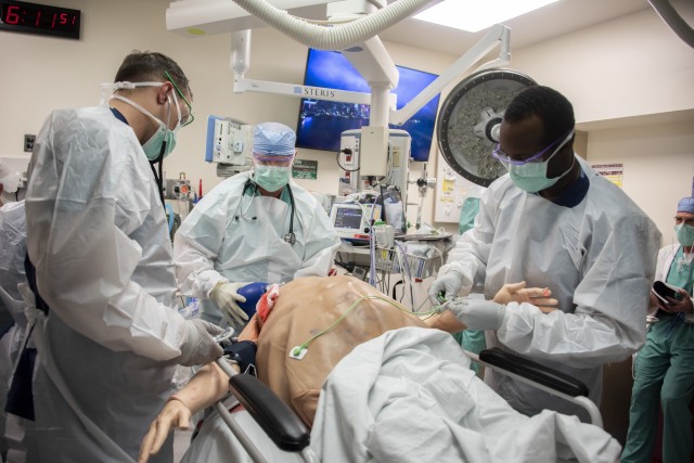 Members of the 555th Forward Surgical Team assess a simulated trauma patient during training with the Strategic Trauma Readiness Center of San Antonio (STaRC) at Brooke Army Medical Center, Fort Sam Houston, Texas, May 28, 2020. The STaRC training...