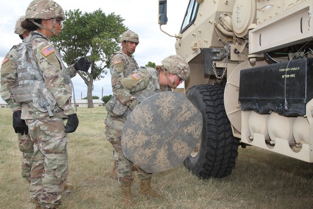 Pvt. Meagan Brewer, an Army National Guard Soldier from Grove, Oklahoma, hefts an outrigger sand pad, a roughly 30-pound bulky metal disc, back onto the TPQ-53 radar. Brewer wanted to become an 11B Infantry Soldier but instead found an MOS she...