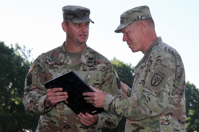 Maj. Gen. Kenneth Kamper, Fires Center of Excellence and Fort Sill commanding general, hands the Army Capabilities Manager charter to Col. Carl Poppe during a change of charter ceremony July 2, 2020, at the Old Post Quadrangle. Poppe was most...