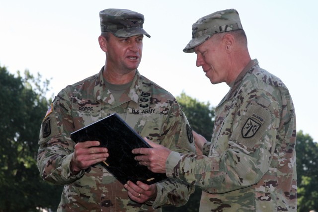 Maj. Gen. Kenneth Kamper, Fires Center of Excellence and Fort Sill commanding general, hands the Army Capabilities Manager charter to Col. Carl Poppe during a change of charter ceremony July 2, 2020, at the Old Post Quadrangle. Poppe was most recently the Directorate of Training Development and Doctrine director.
