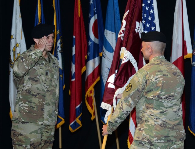 Command Sgt. Maj. Kyle Brunell salutes the Regional Health Command Europe flag during an assumption of command and assumption of responsibility ceremony July 9 at Kleber Kaserne, Germany.  Brunell assumed responsibility as the Regional Health...