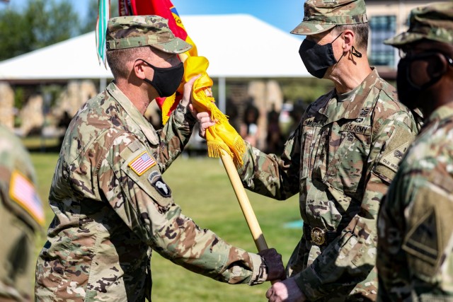 FORT BLISS, Texas -- Col. Marc Cloutier, commander (outgoing) of 3rd Armored Brigade Combat Team, 1st Armored Division hands the Bulldog Brigade Colors to Maj. Gen. Patrick Matlock, commander of 1st Armored Division, III Armored Corps at the Bulldog Brigade Change of Command Ceremony at Fort Bliss, Texas, July 9. (U.S. Army photo by Staff Sgt. Alon Humphrey)