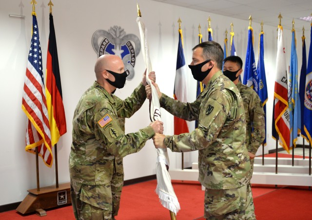 Col. Doug LeVien, right, passes the U.S. Army Medical Materiel Center-Europe's colors to incoming commander, Col. Shane Roach, during a Change of Command ceremony on July 9. Outgoing commander Col. Jonathan B. Butler is pictured on the right. LeVien, deputy commander of 21st Theater Sustainment Command, served as the representative for Col. Michael Lalor, commander of Army Medical Logistics Command. Lalor presided over the ceremony remotely from Fort Detrick, Maryland.