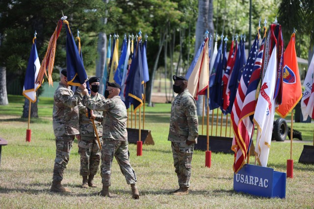 Command Sgt. Maj. Benjamin Jones, outgoing U.S. Army Pacific command sergeant major, pass USARPAC’s unit colors to Gen. Paul J. LaCamera, USARPAC commanding general, at USARPAC’s change of responsibility ceremony July 10, 2020, at Historic Palm Circle, Fort Shafter, Hawaii. The passing of colors signifies the transfer of responsibility to Command Sgt. Maj. Scott A. Brzak, incoming USARPAC command sergeant major. (U.S. Army photo by Sgt. 1st Class Keith Gill, U.S. Army Pacific public affairs)