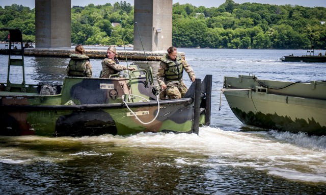 Soldiers assigned to the Connecticut National Guard's 250th Multi-Role Bridge Company drive their Bridge Erection Boat into position to grab a section of a Improved Ribbon Bridge on the Thames River in New London, Connecticut, June 10, 2020. The IRB team practiced creating a five-float raft which is designed to transport troops, equipment, and vehicles across a river.