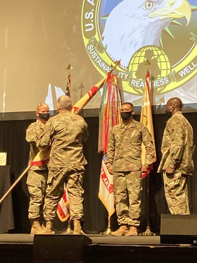 Col. Alicia M. Masson, incoming commander, receives the command’s colors from Lt. Gen. Douglas M. Gabram, Installation Management Command commanding general, during a change of command ceremony at Fort Sam Houston in San Antonio. 