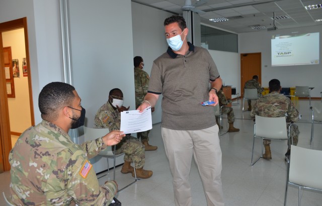 VICENZA - Giulio Rigodanzo, U.S. Army Garrison Italy installation sponsorship liaison hands out material about the Total Army Sponsorship Program training during the class offered on Caserma Ederle July 8. TASP is designed to help prepare...
