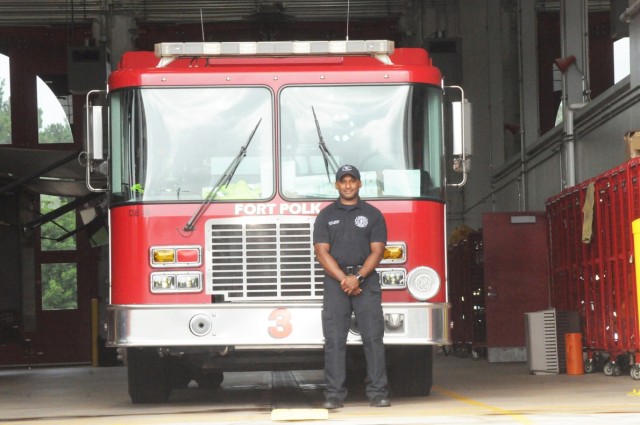 Carlos Jackson, a Fort Polk fire inspector and reserve Airman in the U.S. Air Force, 307th Force Support Squadron, stands in front of a fire truck at Fort Polk's Central Fire Station July 8.