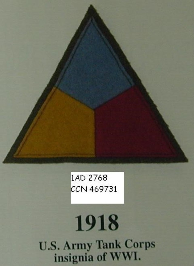Fort Bliss, Texas - 1918: WWI Tank Corps Insignia Shoulder Patch 
This triangle symbolized an old heraldic element of armorial design known as a Pile -- the head of a spear. Tanks were actually the spearhead element in the engagements in which they took part in World War I. It included the three branch colors; blue for infantry, red for artillery, and yellow for cavalry – representing the three combat arms of the Army and components of Armor. Part of the 1st Armored Division & Fort Bliss Museum collection. (Image courtesy of the 1st Armored Division & Fort Bliss Museum)