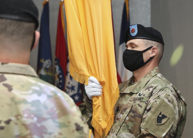 CAMP ZAMA, Japan – Command Sgt. Maj. Neil H. Sartain, 38th Air Defense Artillery Brigade outgoing senior enlisted advisor, prepares to pass the brigade colors, signifying his relinquishment of responsibility. The Pacific Guardian Brigade bid...