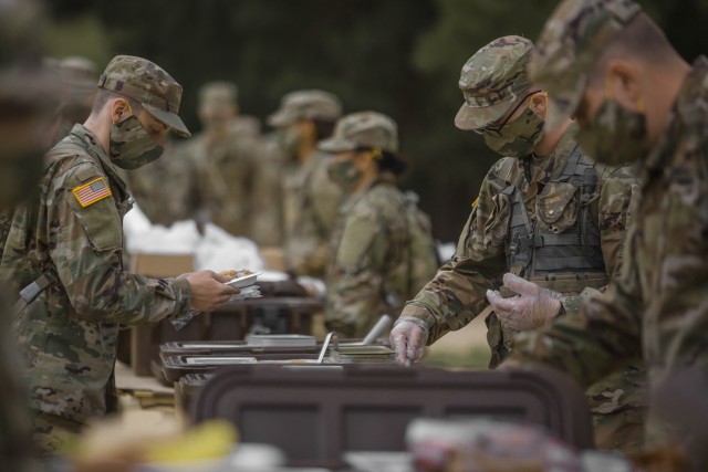 Soldiers in initial military training at Fort Jackson, S. C., line up to eat, May 11, 2020.
