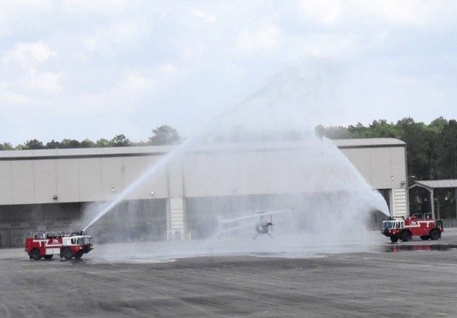 A veteran OH-58 helicopter receives a "water salute," in keeping with aviation tradition, following the Kiowa helicopters’ last flight July 9 at the Joint Readiness Training Center and Fort Polk's airfield.