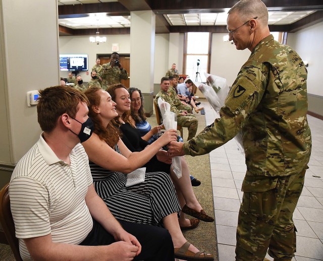 Col. Garrett Kolo, outgoing commander, LOGCAP Support Brigade, gives a rose to his daughter during the LOGCAP Support Brigade change of command ceremony July 10 in Heritage Hall, Rock Island Arsenal, Illinois. (Photo by Jon Micheal Connor, ASC Public Affairs)