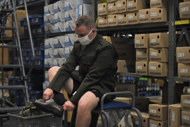A recruiting student from the Fort Knox, Kentucky, Army Recruiter Course tries on a pair of brown shoes as part of the new anticipated Army Green Service Uniform, similar to the World War II-style uniforms worn by Soldiers during that time period.