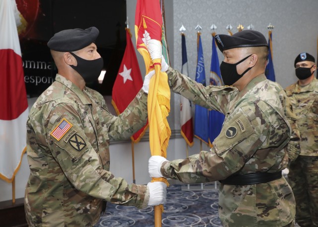 CAMP ZAMA, Japan – Maj. Gen. Viet X. Luong, commanding general, U.S. Army Japan, passes the 38th Air Defense Artillery Brigade colors to incoming brigade Commander Col. Matthew W. Dalton. The Pacific Guardian Brigade bid farewell to their command team and welcomed a new one during a change of command and relinquishment of responsibility ceremony here July 10. (U.S. Army photo by Honey Nixon, U.S. Army Japan Public Affairs)