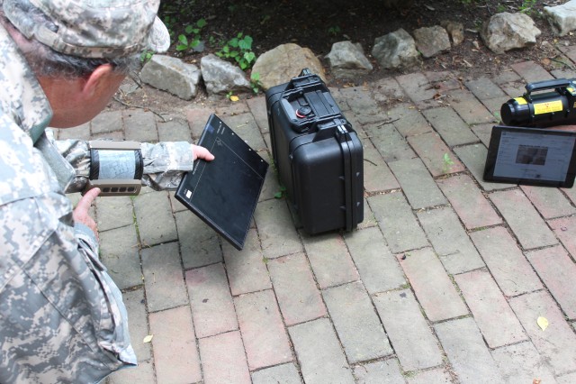 Researchers envision explosive ordnance disposal Soldiers wearing a future flexible wrist display unit using a digital detector array with flexible imaging and an X-ray generator to determine if there is explosive ordnance present. 