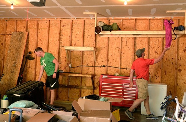 Maj. Mike Scaletty, incoming Command and General Staff Officer Course student, and his brother, John Scaletty, from Fair Grove, Mo., organize his garage July 10 on post. John helped Mike with the do-it-yourself move from Fort Belvoir, Va., to Fort Leavenworth using two large moving trucks. Photo by Prudence Siebert/Fort Leavenworth Lamp