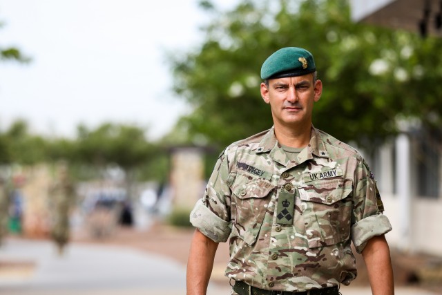British Army Brig. Gen. Leigh Tingey, the deputy commanding general-maneuver of 1st Armored Division, poses in front of the 1AD headquarters at Fort Bliss, Texas, July 1. Tingey provided his leadership and experience to 1AD as the DCG-M since 2018, impacting and influencing Soldiers at all levels. (U.S. Army photo by Pfc. Matthew Marcellus)