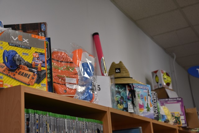WIESBADEN, Germany - Prizes for the Wiesbaden Library’s virtual summer reading program are placed atop book shelves. Library patrons can sign up at wiesbaden.armymwr.com and complete challenges and log minutes of reading to earn virtual tickets...