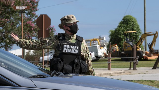 Staff Sgt. Danielle Kam, a Military Policeman with the 17th Military Police Battalion, directs traffic July 10 during free drive through COVID-19 testing on Fort Jackson. The installation, in cooperation with the Medical University of South...
