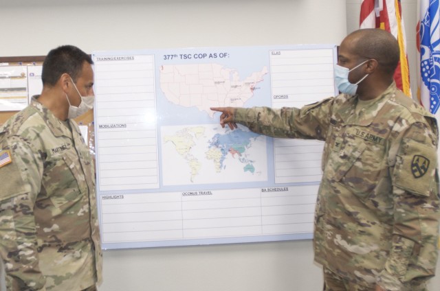 Col. Reggie Richardson (right), the 377th Theater Sustainment Command Deputy Chief of Staff, reviews recent coronavirus activity with Sgt. 1st Class Edward Martinez, support operations noncommissioned officer in charge of supply and services, at...