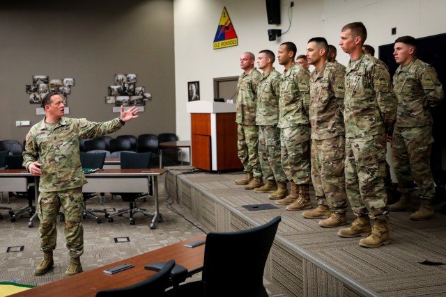 FORT BLISS, Texas – Command Sgt. Maj. Robert H. Cobb, left, the senior enlisted advisor for 1st Armored Division and Fort Bliss, speaks to a group of Soldiers assigned to 1AD who are about to receive the Master Gunner Identification Badge during a ceremony Feb. 4. The MGIB is awarded to noncommissioned officers who have completed one of eight master gunner courses specializing in a combat arms branch which trains weapons systems mastery. (U.S. Army photo by Pvt. Matthew Marcellus)