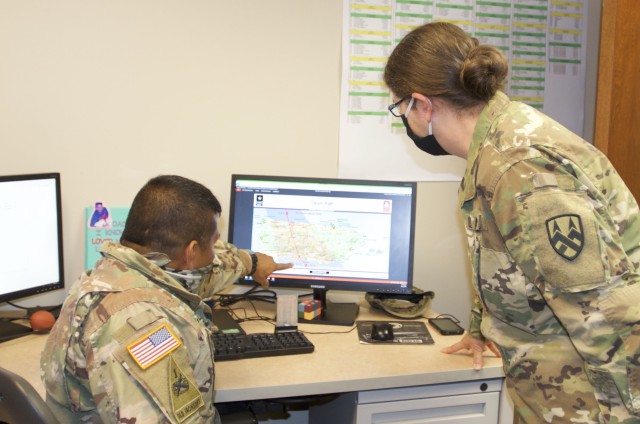 Chief Warrant Officer 4 Dorian Bozza (left), senior maintenance technician at the 377th Theater Sustainment Command, discusses operational planning with Sgt. Maj. Susan Curtis, 377th TSC chief personnel noncommissioned officer, at the command...