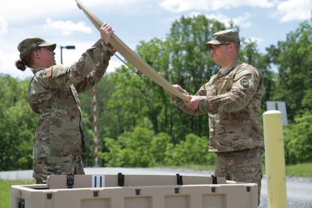 Pfc. Cassie Cowell and Sgt. Zachary Teisher, human resource specialists with the 213th Personnel Company, 728th Combat Sustainment Support Battalion, 213th Regional Support Group, Pennsylvania Army National Guard, assemble a very small aperture terminal communications satellite at Fort Indiantown Gap, June 8, 2017. NetModX is an annual field-based experiment event that informs acquisition decisions, Army science and technology (S&T) specifications, requirements and strategies. 