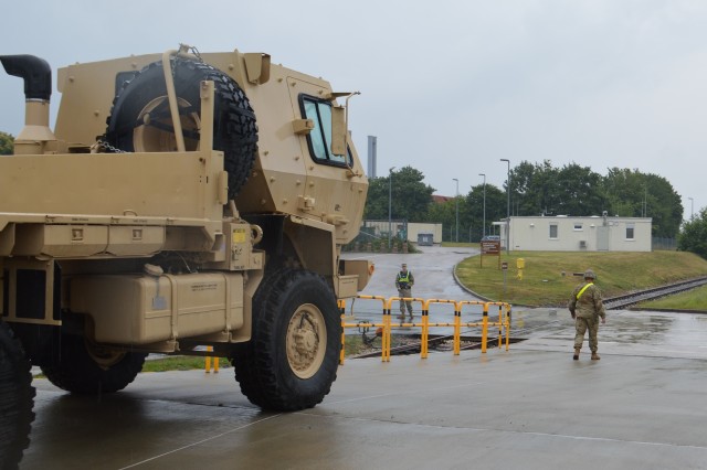 A 101st Combat Aviation Brigade Soldier ground guides a truck which was offloaded from a train July 16, 2020, during the largest rail operation U.S. Army Garrison Ansbach, Germany, conducted in more than 10 years. The trucks and equipment belong to the 101st CAB, the incoming Regionally Allocated Force that will be stationed at Storck Barracks, Illesheim, for their nine-month rotation supporting Atlantic Resolve. The Katterbach Railhead provides U.S. Army in Europe an additional power projection platform capability to deploy arriving and departing brigade-size elements to meet strategic objectives.