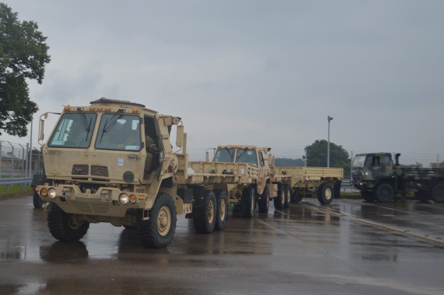 Trucks prepare to convoy after being offloaded from a train July 16, 2020, during the largest rail operation U.S. Army Garrison Ansbach, Germany, conducted in more than 10 years. The trucks and equipment belong to the 101st Combat Aviation Brigade, the incoming Regionally Allocated Force that will be stationed at Storck Barracks, Illesheim, for their nine-month rotation supporting Atlantic Resolve. The Katterbach Railhead provides U.S. Army in Europe an additional power projection platform capability to deploy arriving and departing brigade-size elements to meet strategic objectives.