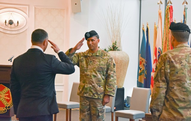WIESBADEN, Germany - Col. Mario Washington salutes Tommy Mize, director of Installation Management Command Directorate-Europe, during a change of command ceremony July 17 at U.S. Army Garrison Wiesbaden in which Washington assumed command of the...