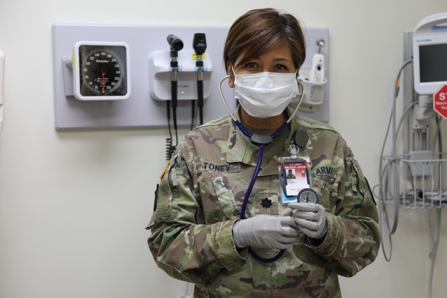 Lt. Col. Dolores Toney, a family nurse practitioner assigned to U.S. Army Medical Department Activity – Japan, poses for a photo May 11 in her examining room at the BG Crawford F. Sams U.S. Army Health Clinic Japan on Camp Zama, Japan. Toney, who has been in the medical field in the Army for 19 years, recently faced one of her most challenging and fulfilling experiences during the height of the COVID-19 pandemic. 