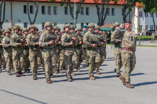 British Army Soldiers assigned to Legion Troop march during the pass in review portion at a change of command ceremony in Bemowo Piskie Training Area, Poland, July 17, 2020. After a 6-month rotation, the U.S. Army 3rd Squadron, 2nd Cavalry Regiment was replaced by 2nd Squadron, 2nd Cavalry Regiment. (U.S. Army photo by Cpl. Justin W. Stafford)