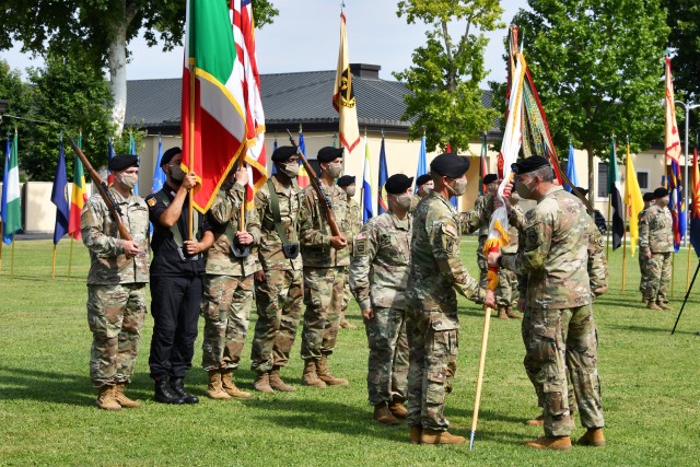 Army Gen. Stephen Townsend, the commander of U.S. Africa Command, passes the U.S. Army Africa command guidon to Maj. Gen. Andrew M. Rohling, the incoming USARAF commanding general, during the USARAF socially distanced change of command ceremony...