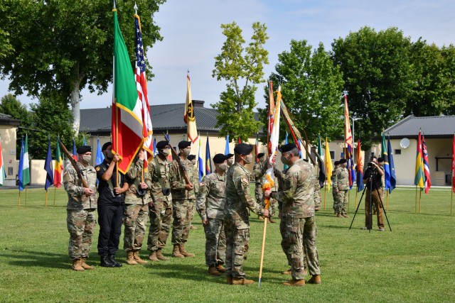 Maj. Gen. Andrew M. Rohling, the incoming U.S. Army Africa commanding general, left, receives the unit colors from Gen. Stephen Townsend, the commander of U.S. Africa Command, during the USARAF change of command ceremony held at Caserma Ederle in...
